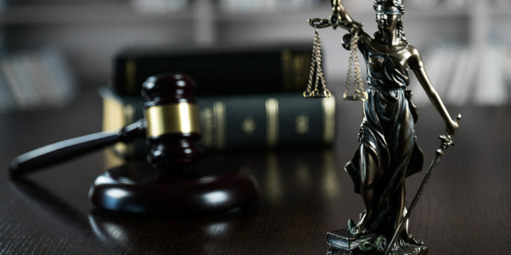 Gavel and lady justice on desk